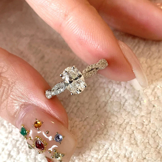 Diamond ring on a finger with a textured background